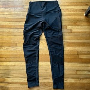 Onzie black leggings with 4 mesh parts in the front of each leg. Size M/L.